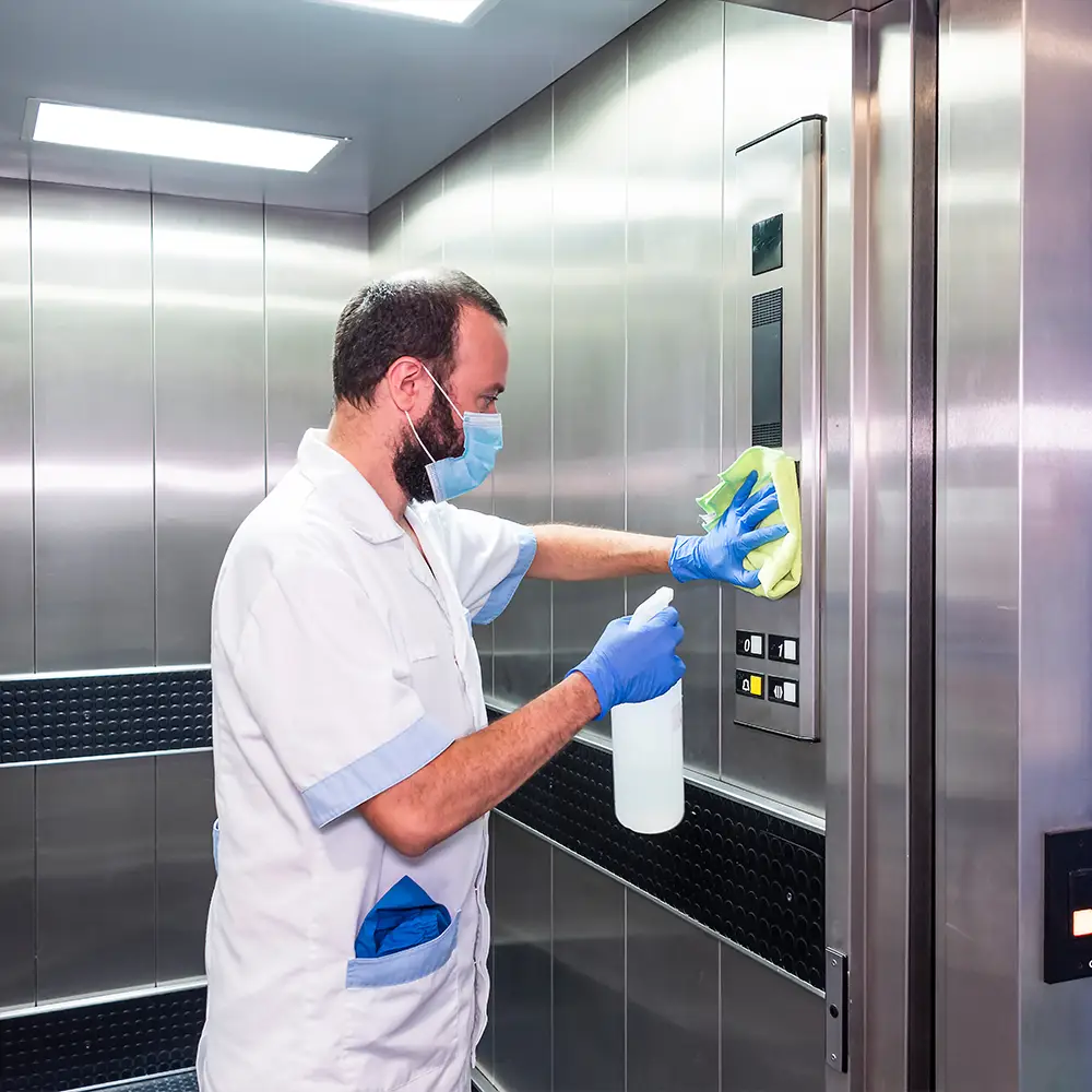 Clean 2 the Kore staff sanitizing stainless steel elevator control panel